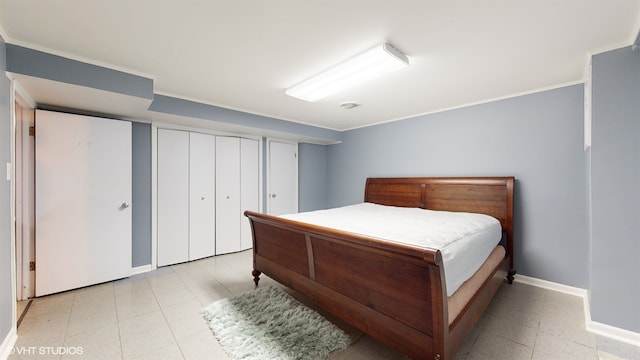 bedroom featuring crown molding and two closets