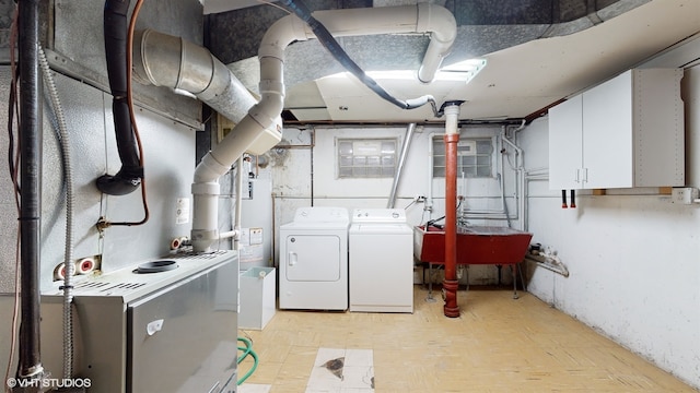 clothes washing area featuring washing machine and dryer and sink