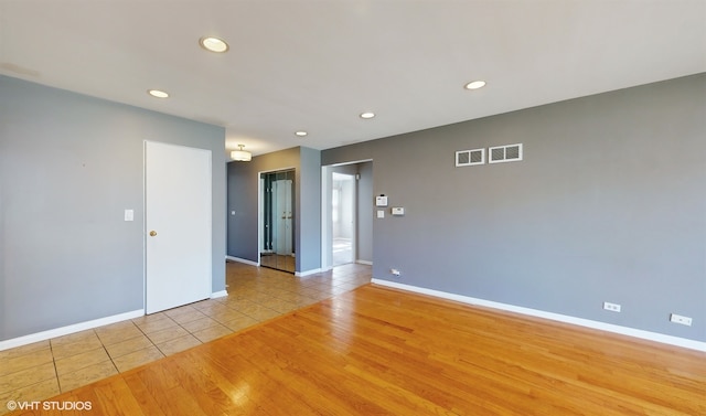 unfurnished room with light wood-type flooring