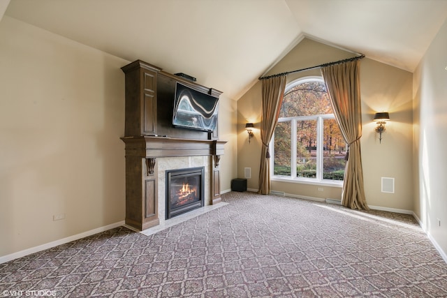 unfurnished living room with carpet floors and vaulted ceiling