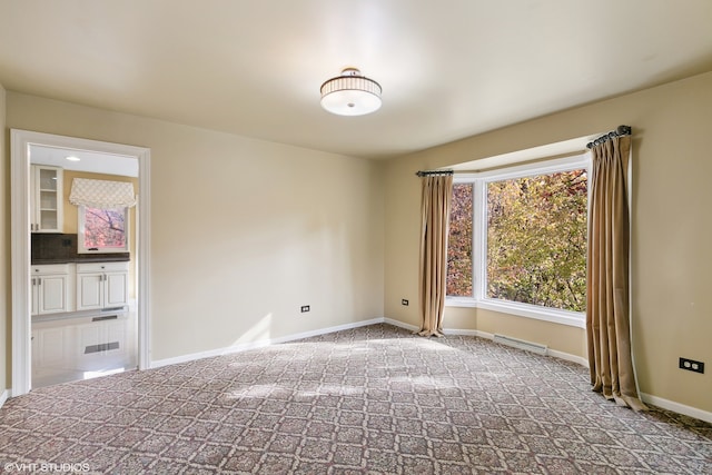 unfurnished room featuring carpet