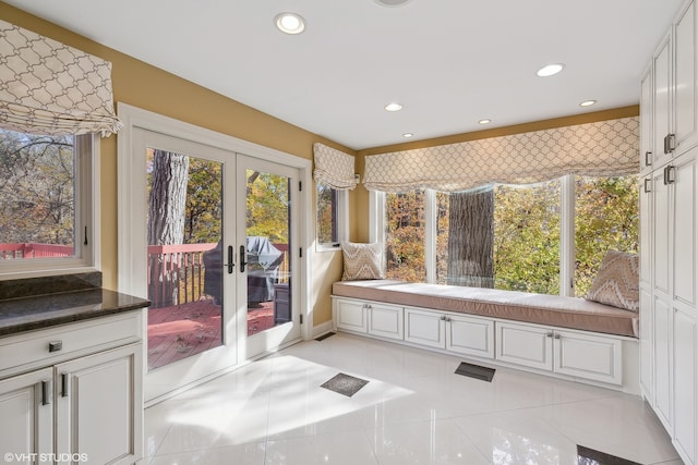 bathroom featuring a wealth of natural light, french doors, and tile patterned flooring