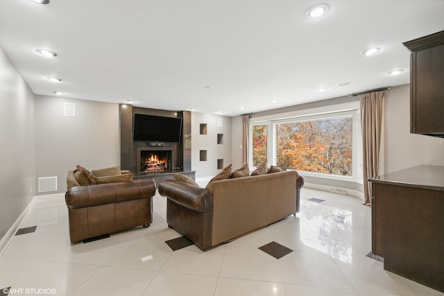 tiled living room featuring a tile fireplace