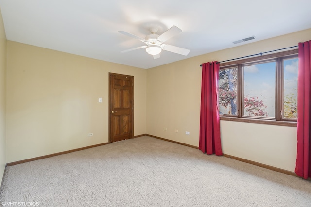 empty room featuring carpet floors and ceiling fan