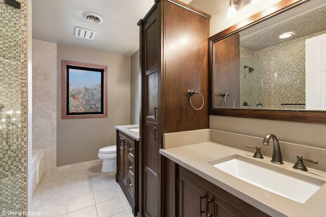 full bathroom with vanity, tiled shower / bath, toilet, and tile patterned flooring