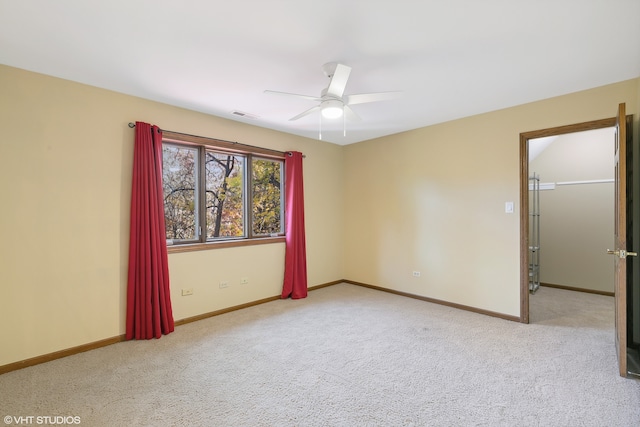 empty room featuring light colored carpet and ceiling fan