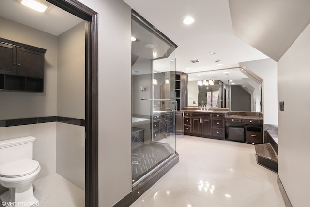 bathroom with vanity, toilet, and tile patterned floors