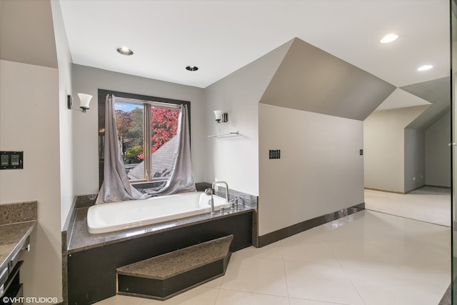 bathroom featuring vanity, a tub to relax in, and tile patterned floors