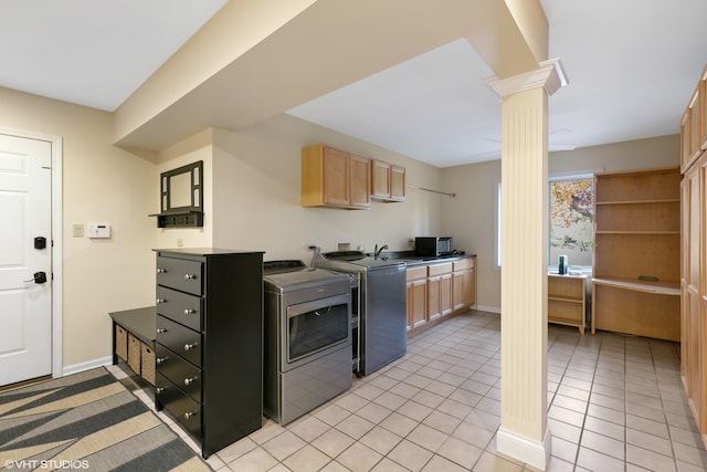 kitchen with light brown cabinets, ornate columns, sink, light tile patterned floors, and washer and dryer