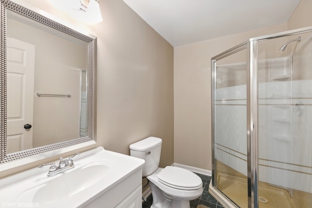 bathroom featuring toilet, an enclosed shower, vanity, and tile patterned flooring