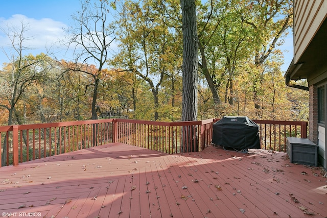 wooden deck with a grill