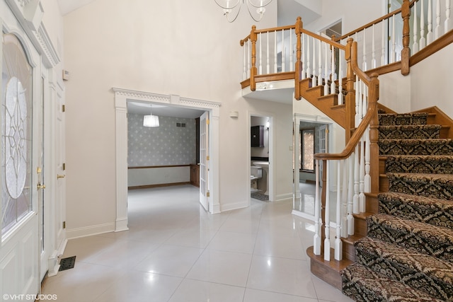 entrance foyer with a high ceiling and light tile patterned floors