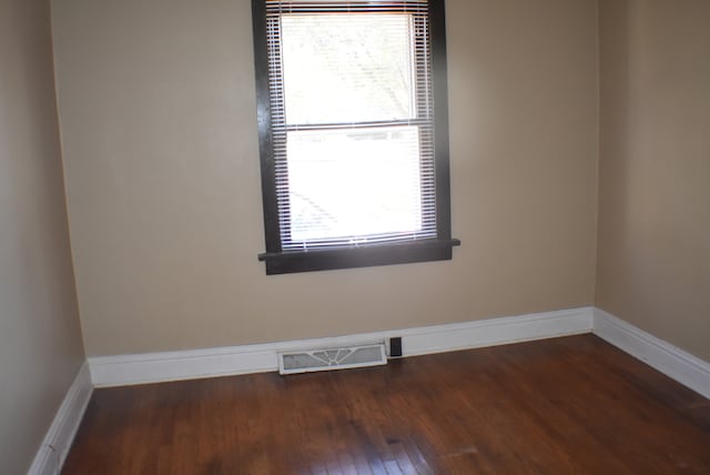 spare room featuring dark hardwood / wood-style floors