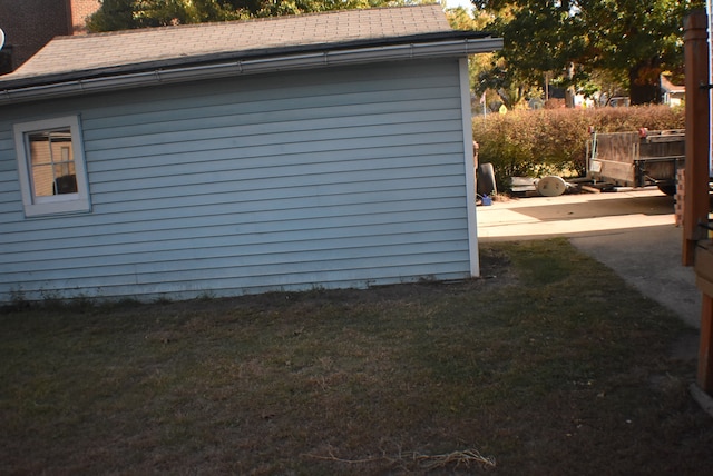 view of side of property with a patio and a lawn