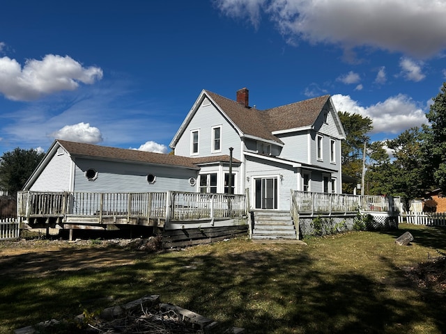 back of property featuring a yard and a wooden deck