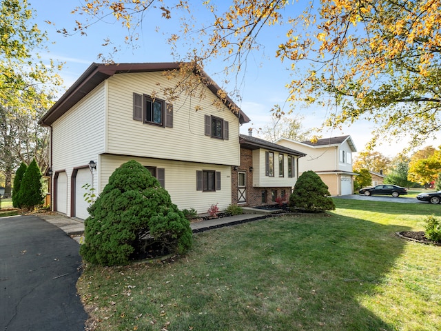 tri-level home featuring a front yard and a garage