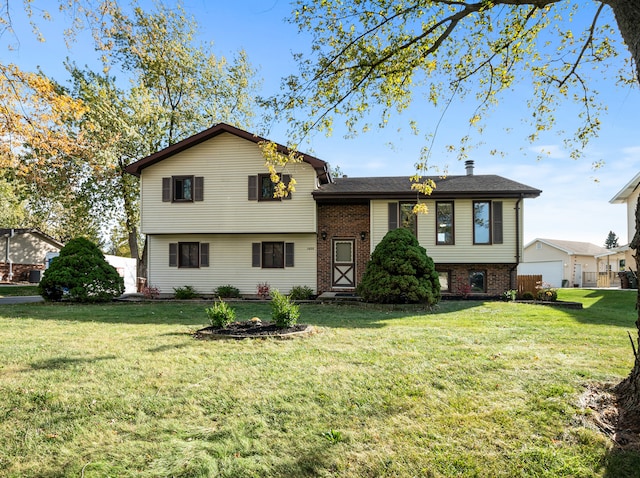 tri-level home with a front lawn