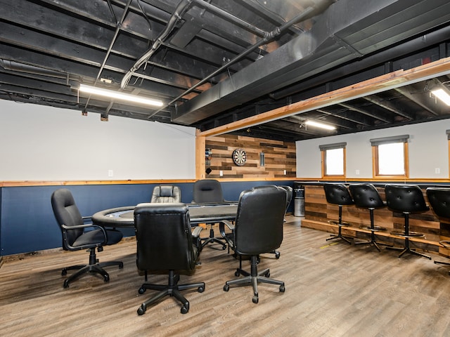 office featuring hardwood / wood-style floors and wood walls