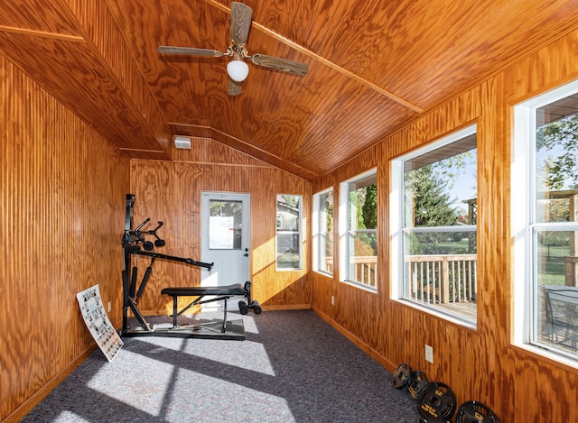 workout area with wood walls, ceiling fan, wooden ceiling, vaulted ceiling, and carpet