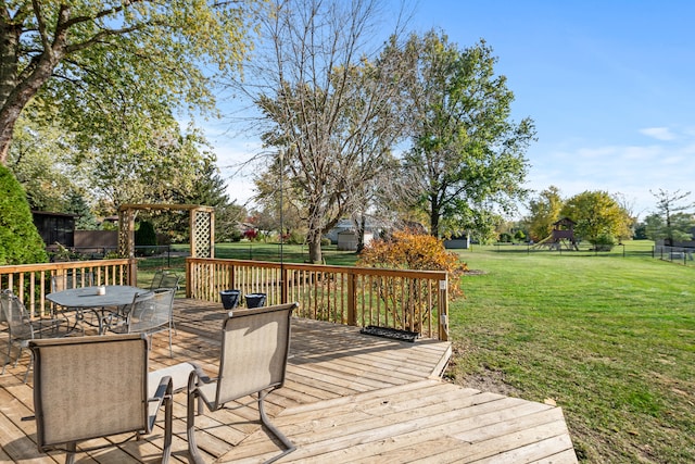 deck featuring a lawn and a playground