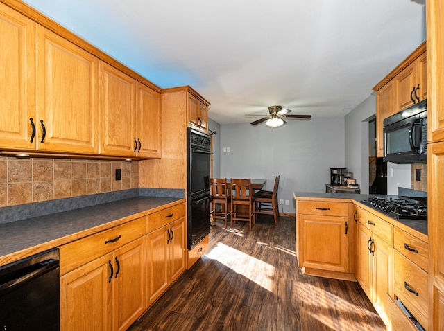 kitchen with black appliances, ceiling fan, tasteful backsplash, and dark hardwood / wood-style flooring