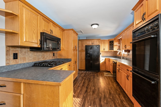 kitchen featuring decorative backsplash, black appliances, sink, and dark hardwood / wood-style floors