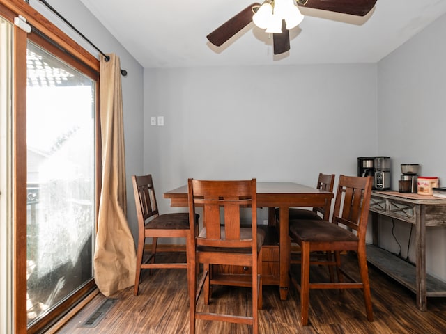 dining room with dark hardwood / wood-style floors and ceiling fan