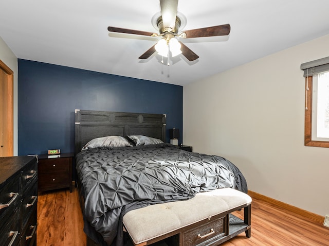 bedroom with wood-type flooring and ceiling fan