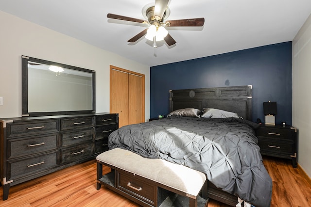 bedroom with a closet, ceiling fan, and light wood-type flooring