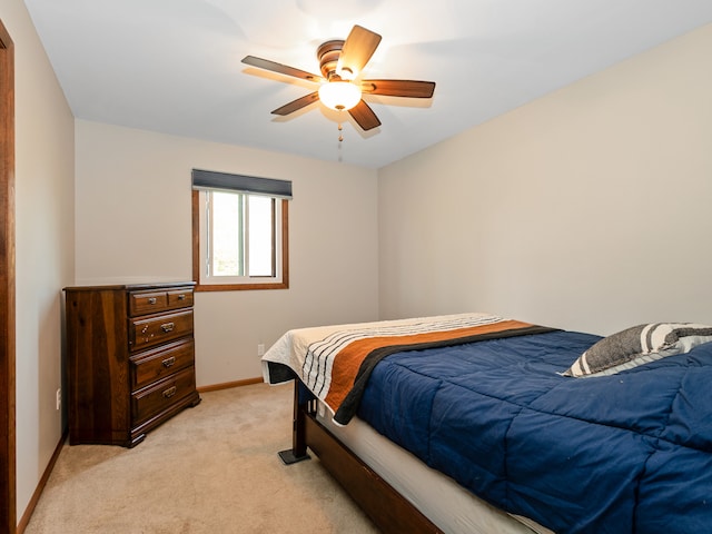 bedroom with light carpet and ceiling fan