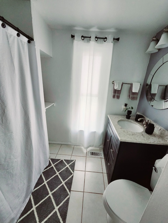 full bathroom with tile patterned flooring, vanity, toilet, and shower / tub combo with curtain