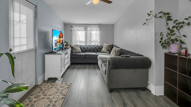 living room featuring ceiling fan, dark hardwood / wood-style flooring, and a healthy amount of sunlight