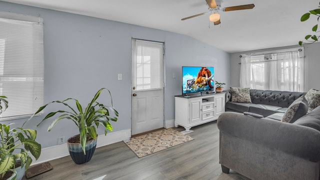 living room featuring hardwood / wood-style floors, ceiling fan, and lofted ceiling