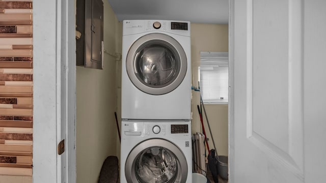 washroom featuring stacked washing maching and dryer