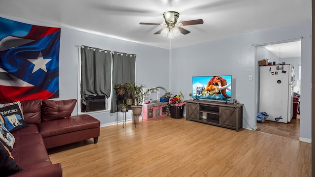 living room featuring light wood-type flooring and ceiling fan