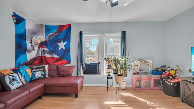 living room featuring ceiling fan and light wood-type flooring