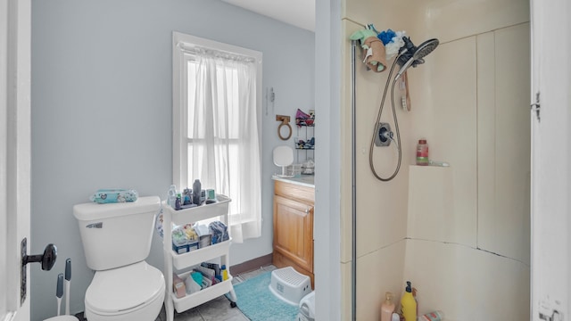 bathroom with toilet, a healthy amount of sunlight, a shower, and vanity