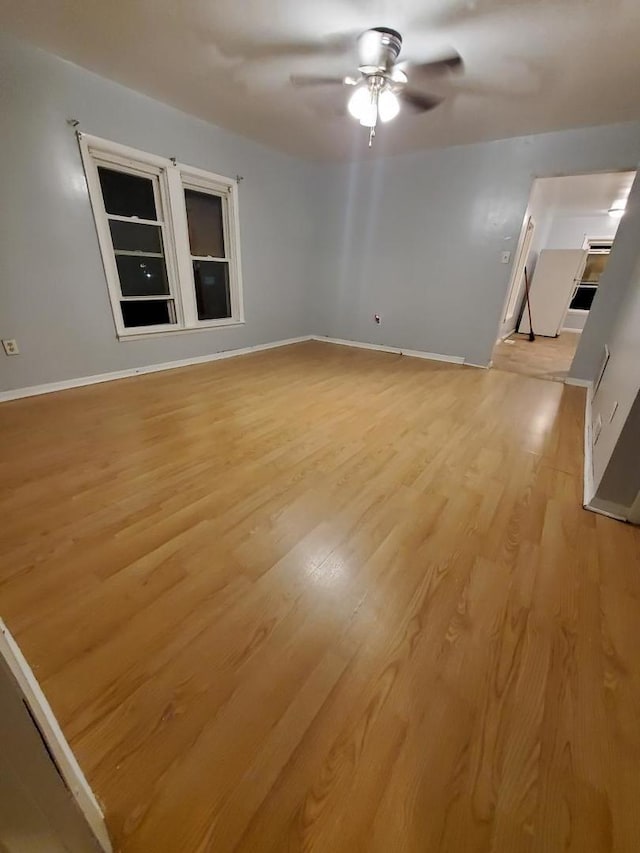 unfurnished living room featuring ceiling fan and light hardwood / wood-style floors