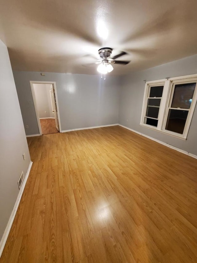 unfurnished room featuring ceiling fan and light wood-type flooring