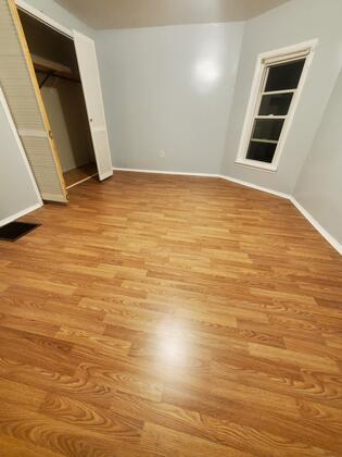 unfurnished bedroom featuring light hardwood / wood-style floors and a closet