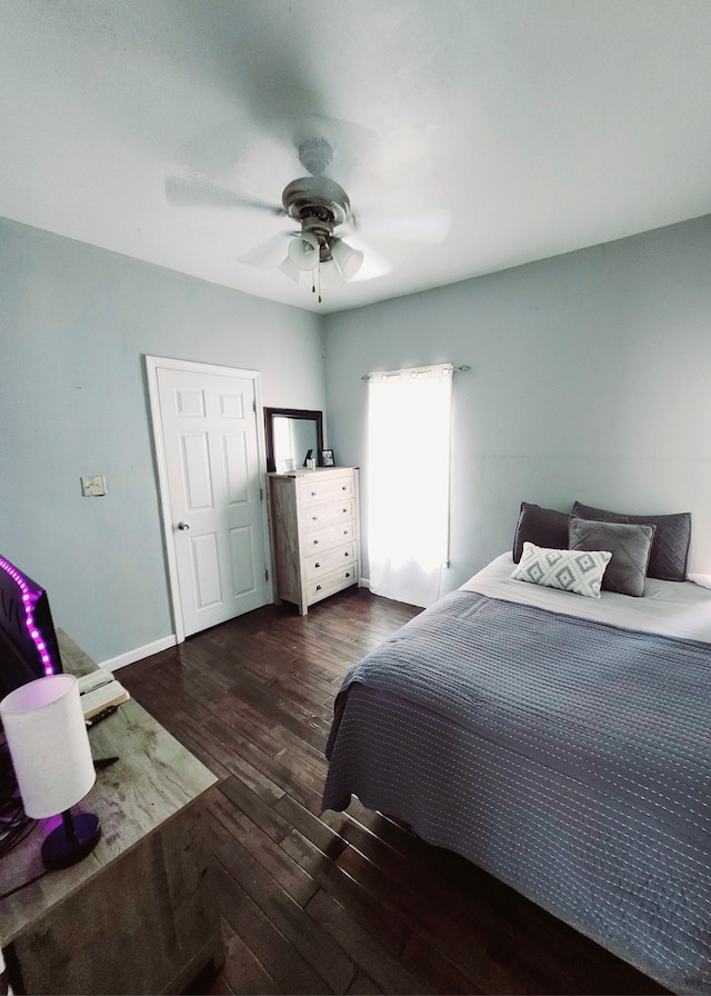 bedroom with ceiling fan and dark hardwood / wood-style flooring