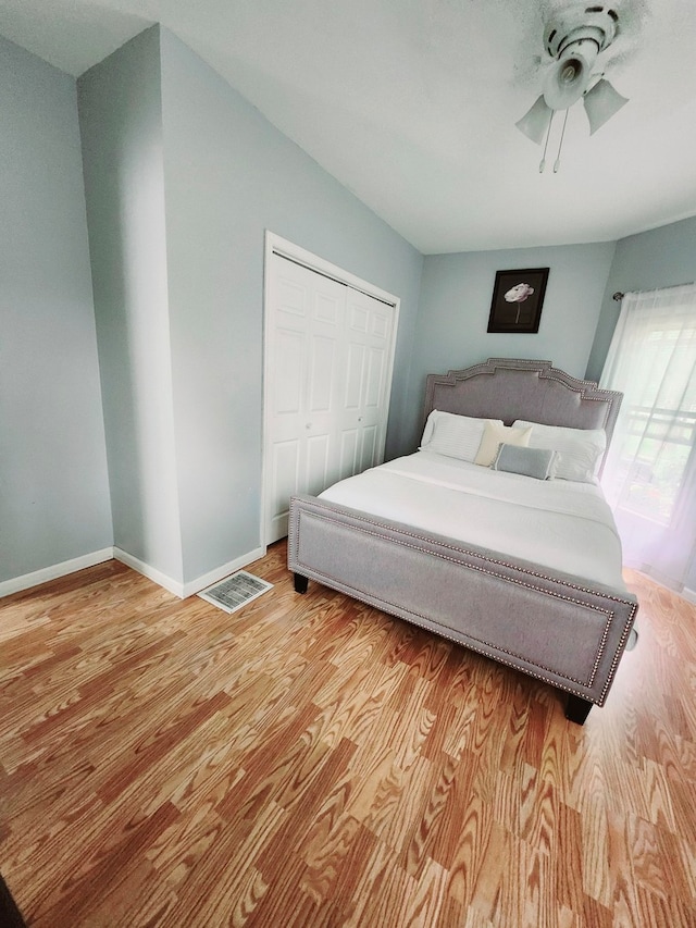 bedroom featuring ceiling fan, a closet, and light hardwood / wood-style floors