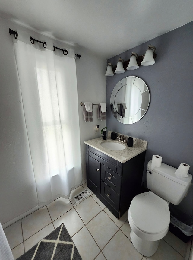 full bathroom featuring tile patterned flooring, shower / bath combo, vanity, and toilet