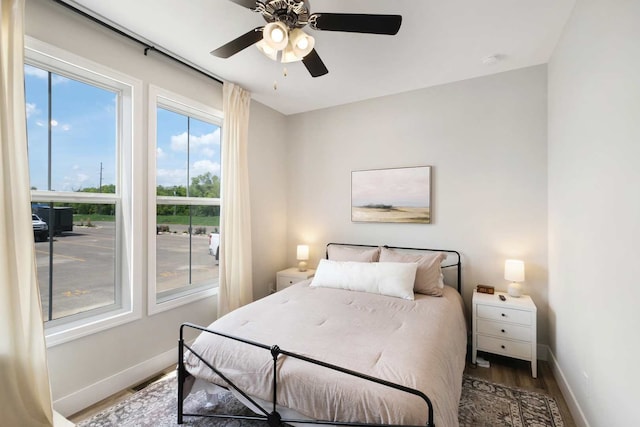 bedroom with ceiling fan and hardwood / wood-style flooring