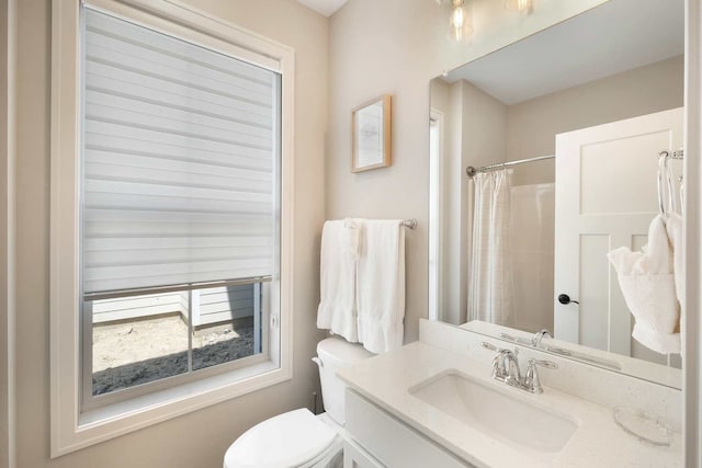 bathroom featuring vanity, toilet, and a shower with curtain