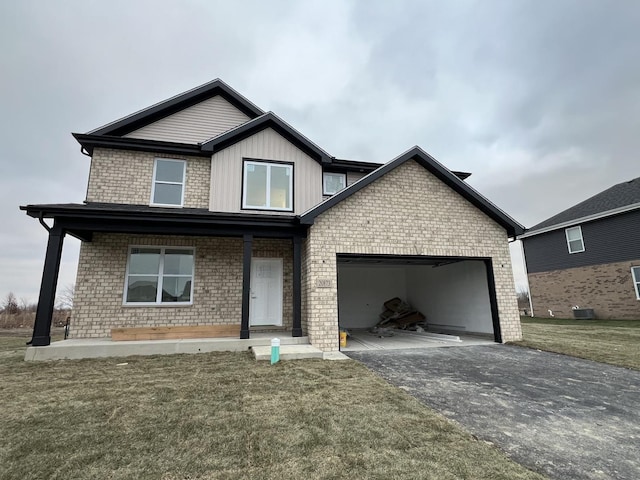 view of front of home with a front lawn and a garage