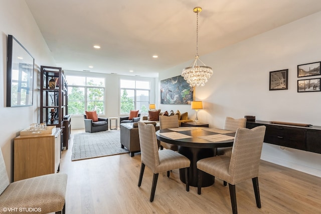 dining room featuring a chandelier and light wood-type flooring