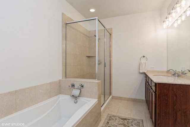 bathroom featuring shower with separate bathtub, tile patterned floors, and vanity