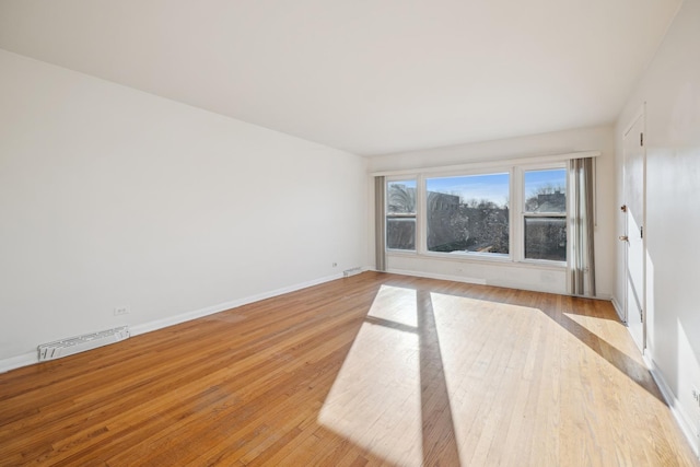 spare room with light hardwood / wood-style flooring