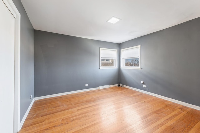 spare room with cooling unit and light hardwood / wood-style flooring